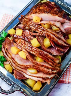 ham with pineapples and parsley on a platter