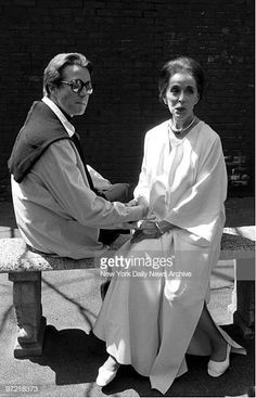 two people sitting on a bench shaking hands