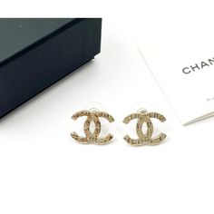 This is part of Chairish’s Costume Jewelry assortment.  Chanel Gold CC Hieroglyphs Piercing Earrings  *Marked 19 *Made in France *Comes with the original box, pouch and booklet  -It is approximately 0.75" x 0.5". -In a pristine condition High-end Gold Earrings For Gift, Luxury Gold Engraved Earrings, Luxury Engraved Gold Earrings, Gold Jewelry For Anniversary In Original Box, Gold Jewelry For Anniversary With Original Box, Luxury Engraved Earrings For Anniversary, Box Pouch, Piercing Earrings, Balenciaga Designer