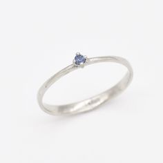 Dainty Sapphire Ring set with Natural Sapphire, size 2 millimeters diameter, 0.03 Carats. Solid 14k White Gold ☞ made to last. Click here for ☞ Solid Gold CollectionSapphire Details:• CERTIFIED Sapphire • Weight: 0.03 Carats• Dimensions: 2 millimeters• Color: Blue• Cut: Round• Origin: BurmaSetting Details:• 1.20 grams of 14k Solid White Gold• Dimensions: Band width ≈ 2.2mm, thickness ≈ 0.7mm• Non-Tarnish - Perfect for Everyday Use - Lasts a Lifetime *Final weight & dimensions depending on the ch White Gold Sapphire Ring, Sapphire Solitaire Ring, Gold Letter Necklace, Sapphire Solitaire, Jewelry Safe, Solid Gold Jewelry, 14k White Gold Ring, Silver Gifts, White Gold Ring