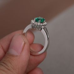 This is a gorgeous handmade creation. Its beauty is its simplicity & Elegance. The 6*8mm lab emerald is crafted in solid sterling silver and with rhodium plated. It's made to order and it will take about 7-10 days to make it. All item is sent in a beautiful gift box You can realize more lovely stuff clicking the link https://www.etsy.com/shop/knightjewelry?refshopsection_shophome_leftnav Please leave the correct address and you phone number for delivering successfully. Emerald Halo Design Ring As A Gift, Emerald Ring With Halo Design For Promise, May Birthstone Emerald Ring With Halo Design, Emerald Rings With Halo Design For Promise, Emerald Ring With Halo Design For May Birthstone, Emerald Halo Promise Ring, Emerald Halo Design Promise Ring, Round Emerald Ring With Halo Design For May Birthstone, Emerald Halo Ring For May Birthstone Wedding