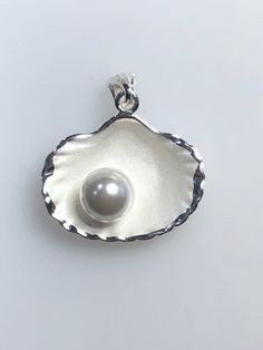 "Sterling Silver shell with simulated pearl  Made in Thailand 925 marked Height 1 1/8\" with bail, Width  1\"" Elegant White Shell Pendant, Elegant Shell With Pearl Charm, Elegant Silver Pendant Shell, Elegant Pearl Drop Shell, Elegant Round Shell As Gift, Elegant Shell Gift, Elegant Round Shell Gift, Elegant Sterling Silver Shell In Silver, Elegant Silver Sterling Shell