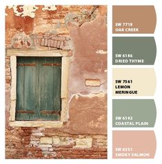 an old brick building with green shutters and paint swatches on the outside wall