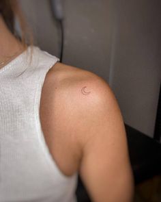 a woman with a small tattoo on her shoulder