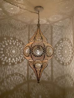 an intricately designed chandelier hangs from the ceiling