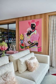 a living room filled with furniture and a painting on the wall