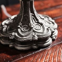 an old fashioned lamp is sitting on a wooden table