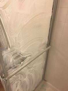 a shower door with white paint on it