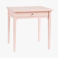 a small pink table with two drawers on each side and one drawer at the top