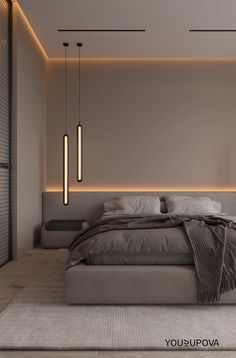 a bed sitting under two hanging lights in a bedroom