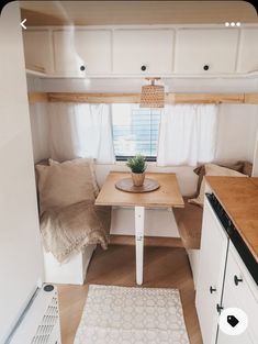 a kitchen area with a table, sink and stove