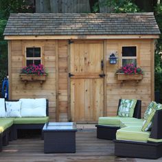 an outdoor living area with couches and chairs