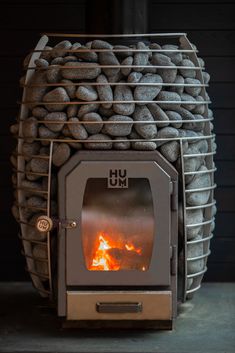 a stove that has some kind of fire burning in it's back end and rocks stacked on top of it