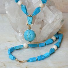 "Bold geometric shapes and bright blue genuine turquoise stone make this necklace a fun, artsy piece of jewelry.  I have used a combination of real blue chalk turquoise, cream-colored river stone and turquoise blue Czech fire-polished beads. The necklace is accented with gold-filled findings. A beautiful chalk turquoise sphere hangs in the center and is artistically wrapped with gold-filled jeweler's wire. This 24-inch chalk turquoise necklace fastens with a gold-filled lobster claw clasp.  Neck Wire Wrapped Turquoise, Handmade Wire Wrapped, Bleu Turquoise, Globe Pendant, Handmade Wire, Genuine Turquoise, Turquoise Pendant, Wrapped Pendant, Wire Wrapped Pendant