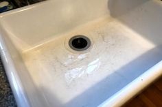 a white sink sitting on top of a wooden floor