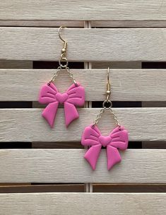 Pink Bow shaped earrings.  Handmade from polymer clay, super lightweight. Measures at 2.25 inches from hook to end. All earrings are made with love! Treat them well, because although they are durable, they are handmade, unique and hard to replace! **No returns or exchanges** If damaged upon delivery please reach out within 2 days of receipt for assistance. Thanks!! Trendy Plastic Earrings For Gift, Cute Pink Bow Earrings For Party, Cute Bow Earrings, Cute Earrings With Pink Bow For Gift, Handmade Pink Plastic Earrings, Pink Bow Earrings In Cute Style, Black Zip Up Hoodies, Cute Pink Earrings With Pink Bow, Pink Hypoallergenic Plastic Earrings