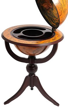 an orange and black globe sitting on top of a wooden stand