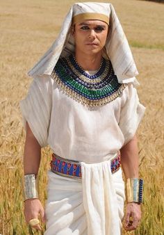 an egyptian woman standing in the middle of a wheat field with her hands on her hips