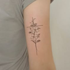 a woman's arm with a flower tattoo on the back of her left arm