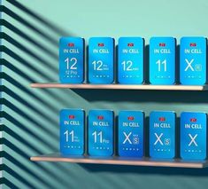 several blue boxes with numbers on them sitting on shelves