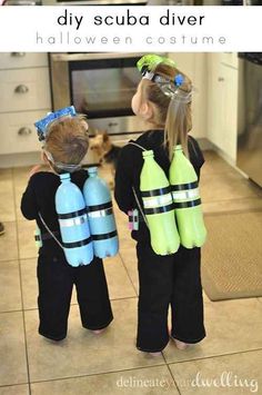 two young children wearing scuba gear in the kitchen