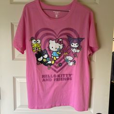 hello kitty and friends t - shirt hanging on the door