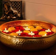 a bowl filled with candles sitting on top of a table