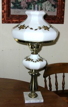 a white lamp sitting on top of a wooden table