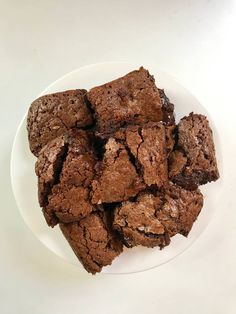 a white plate topped with brownies on top of a table