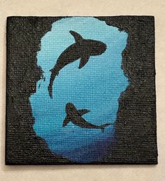 a painting of two dolphins swimming in the ocean on a black and blue background, with one dolphin jumping out of the water