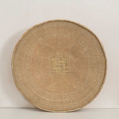 a round woven basket sitting on top of a table