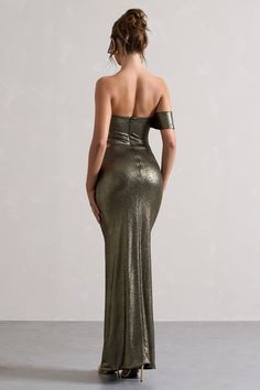 a woman in a gold dress looking back