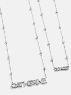 We took our beloved, best-selling Yasmine style and gave it a personalized touch with our Sterling Silver Custom Yasmine Nameplate Necklace. This custom name piece features the personalization of your choosing framed by a contemporary sterling silver chain. Dotted with high-shine Cubic Zirconia bezel stones, this accessory is sure to become a staple in your everyday ensemble. Luxury Engraved Silver Name Necklace, Luxury Silver Nameplate Necklace, Luxury Sterling Silver Custom Name Necklace, Luxury Sterling Silver Nameplate Necklace, Luxury Silver Custom Name Necklace, Luxury Custom Name Sterling Silver Necklace, Luxury Personalized Silver Name Necklace, Silver Tarnish-resistant Nameplate Necklace, Custom Name Sterling Silver Nameplate Necklace