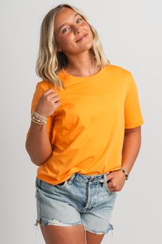 Basic short sleeve t-shirt from Lush Fashion Lounge women's boutique in Oklahoma City. Lush boutique in OKC has a variety of cute basic tops and more! This trendy basic t-shirt is a must have! Pair this basic orange top with shorts and sneakers for a cute and casual look! Model is 5'4 size 26 wearing size small. 100% cotton Orange Solid Color Summer Tops, Basic Solid Color Short Sleeve Tops, Basic Short Sleeve Solid Color Tops, Basic Orange T-shirt For Spring, Trendy Short-sleeved T-shirt In Solid Color, Orange Summer T-shirt For Everyday, Trendy Short Sleeve Solid Color T-shirt, Basic Short Sleeve Top For Spring, Casual Plain Orange Tops