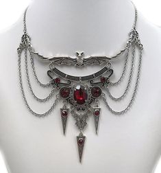 This dramatic Gothic Vampire Bat necklace features an antique silver open winged bat, filigrees and pendants, adorned with dazzling DARK RUBY RED/GARNET glass jewels. This piece is then finished off with perfectly draped stainless steel cable chain. Decorated length portion is  5 3/4" wide and 4" tall in the very center (bat ears to bottom point). Necklace is adjustable 15"-18" in length.  It is worn with soldered stainless steel cable chain and closes with a lobster clasp.If you would like a di Manga Jewelry, Gothic Jewelry Diy, Bat Ears, Vampire Necklace, Vampire Jewelry, Bat Necklace, Victorian Necklace, Jewelry Gothic, Gothic Vampire