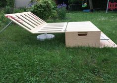 a lawn chair sitting on top of a lush green field