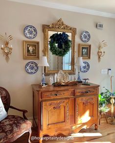 an ornate dresser with blue and white plates on it in the corner of a room