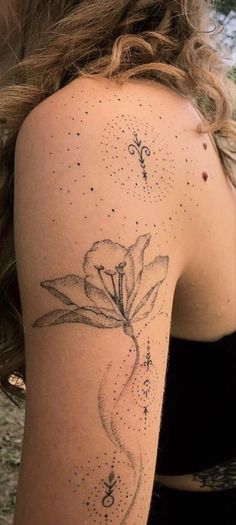 a woman with a flower tattoo on her arm