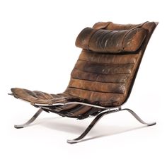 an old leather chair with metal legs