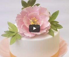 a white cake with pink flowers on top