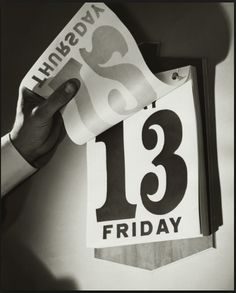 a person holding up a sign with the number thirteen in front of it that reads happy friday