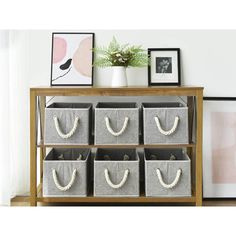 a wooden shelf filled with grey storage baskets