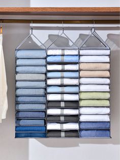 an organized closet with folded towels and folded clothes hanging on the rail, next to a towel rack