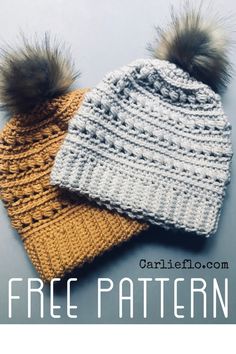 two knitted hats with pom - poms on them