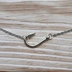 "Really nice looking fish hook necklace!  Hook is silver plated and measures 26x16mm.  16\" stainless steel chain and hook is attached sideways.  Also have this necklace available in other finishes, a longer style that is not sideways or a bead bracelet. *each additional item ships for only $1" Fishing Hook Necklace, Fishing Necklace, Country Jewelry Rings, Western Necklace, Western Stuff, Jewelry Silver, Fish Hook Jewelry, Western Fashion Jewelry, Rodeo Jewelry