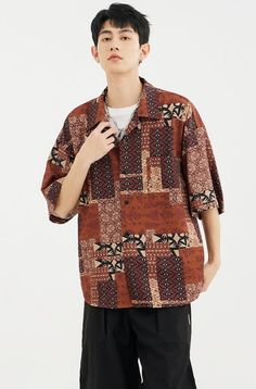 Infuse your wardrobe with the spirit of wanderlust in the Bohemian Paisley Print Short Sleeve Shirt. Constructed from a lightweight, breathable 100% polyester fiber, this shirt features a distinctive paisley print that captures a blend of Southeast Asian influence and beachy retro vibes. The geometric patterns on the lapel-collar design elevate its visual texture, while the loose fit cut ensures both comfort and a contemporary silhouette. Perfect for expressing a relaxed yet stylish demeanor, th Casual Vacation Shirt With Vintage Print, Casual Vintage Print Shirt For Vacation, Bohemian Camp Shirt With Printed Short Sleeves, Bohemian Printed Short Sleeve Camp Shirt, Bohemian Brown Shirt For Summer, Bohemian Brown Summer Shirt, Summer Bohemian Brown Shirt, Casual Shirt With Paisley Print And Relaxed Fit, Casual Patterned Camp Shirt With Abstract Print