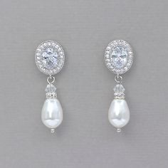 "Our Classic pearl drop earrings are an elegant bridal earring with just enough sparkle. AAA quality oval cubic zircons in a halo design with a Swarovski teardrop pearl in your color choice will add the perfect touch to your wedding day especially if you have an oval engagement ring. Length -approx 1 1/4\"(3.5cm) 💙 Don't have pierced ears? We sell converters that convert postbacks and french hooks to clip on in gold, rose gold and silver tone. Add them to your order and if you require them to b White Oval Earrings For Wedding, White Oval Bridal Earrings For Wedding, Oval White Bridal Earrings For Wedding, Oval Halo Bridal Earrings, Classic Oval Earrings For Wedding, Oval Halo Bridal Earrings For Wedding, Oval Halo Design Bridal Earrings For Wedding, Oval Cubic Zirconia Wedding Earrings, Classic Oval Cubic Zirconia Bridal Earrings