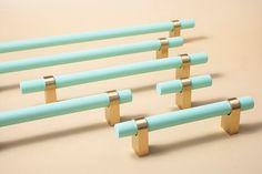 several blue and gold colored objects are arranged in the shape of rods on a beige surface