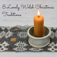 a candle is lit in a small bowl on a rug with the words 8 lovely wish christmas traditions