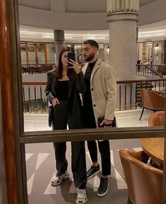 a man and woman taking a selfie in a hotel lobby